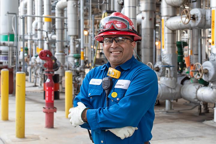 Motiva employee smiling in refinery.