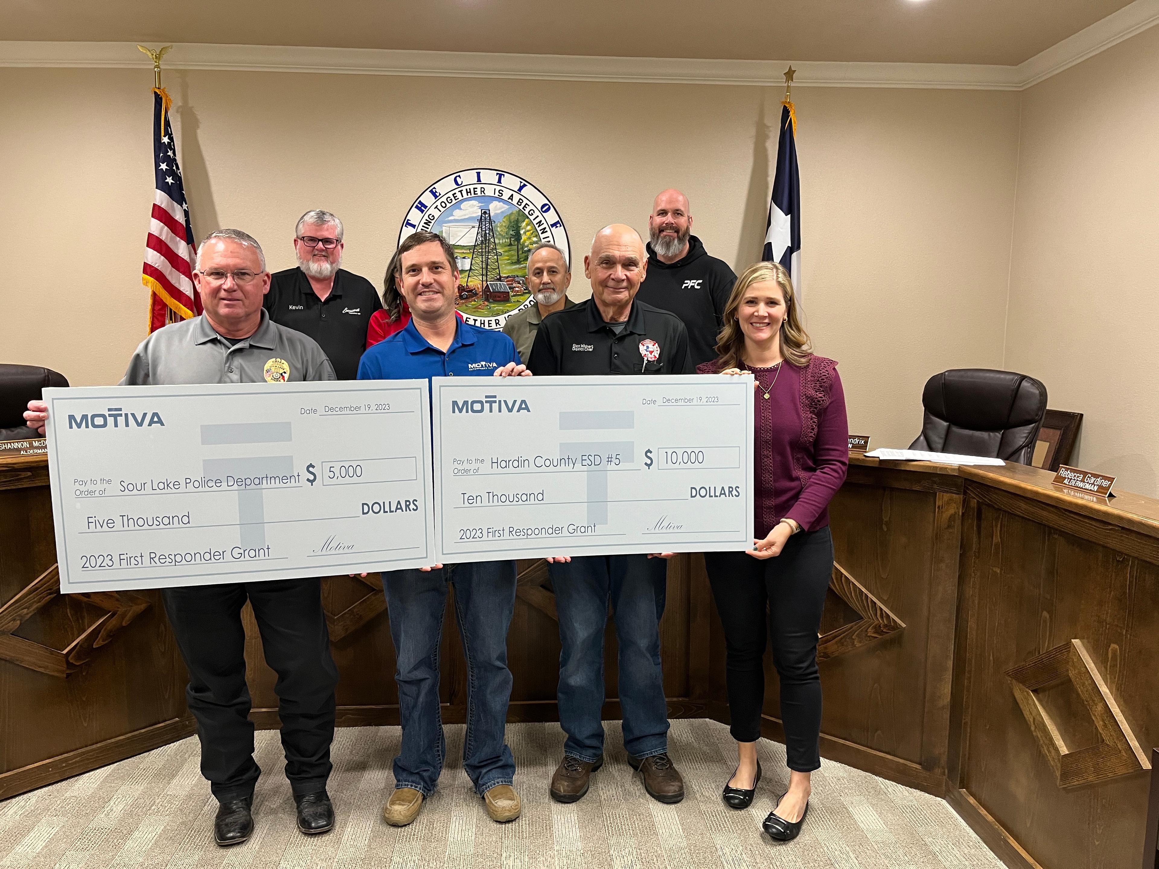 t Arthur Police Department hold up checks as recipients of Motiva's 2023 First Responder Grants.