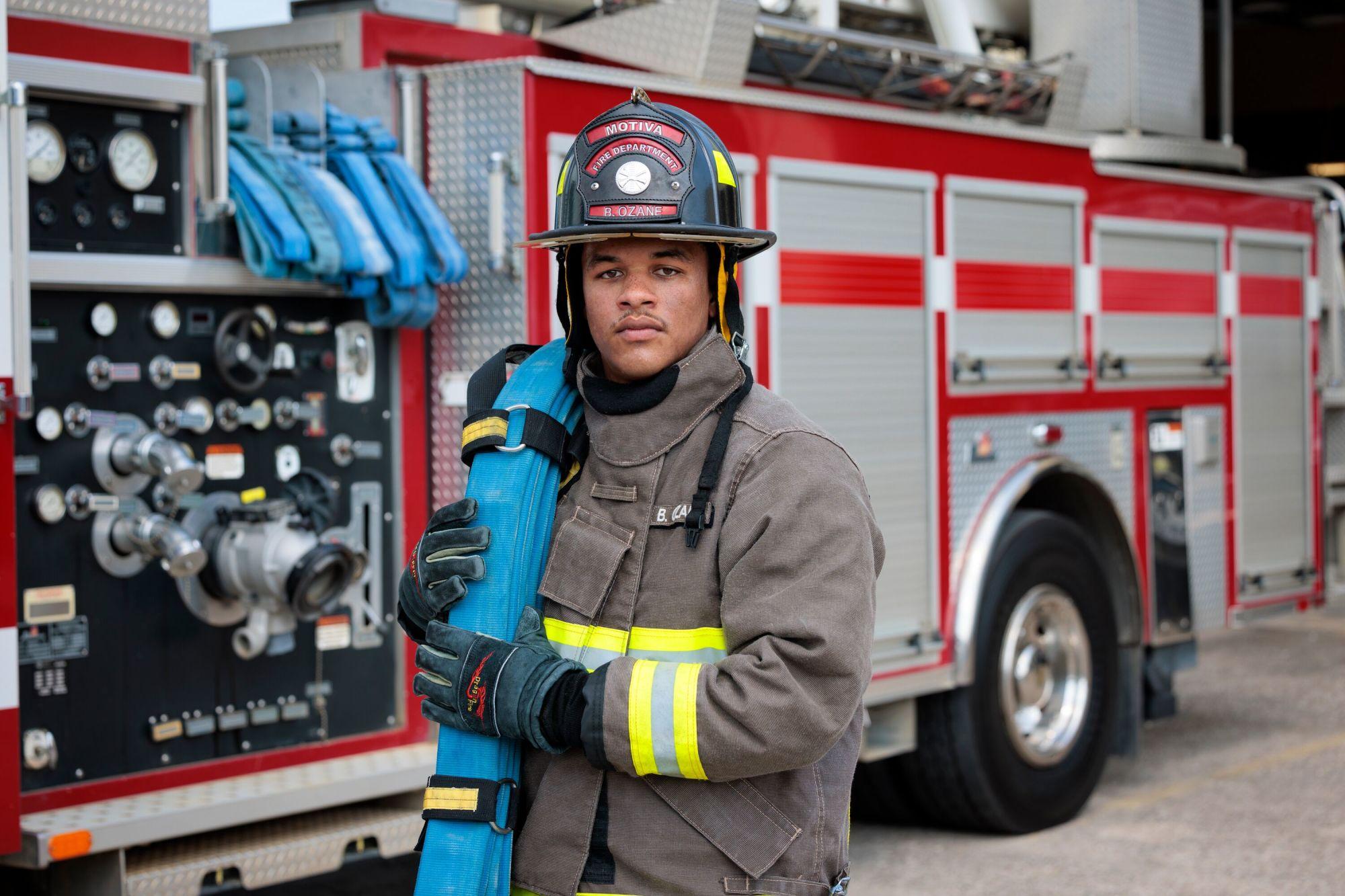 Motiva fireman holding hose