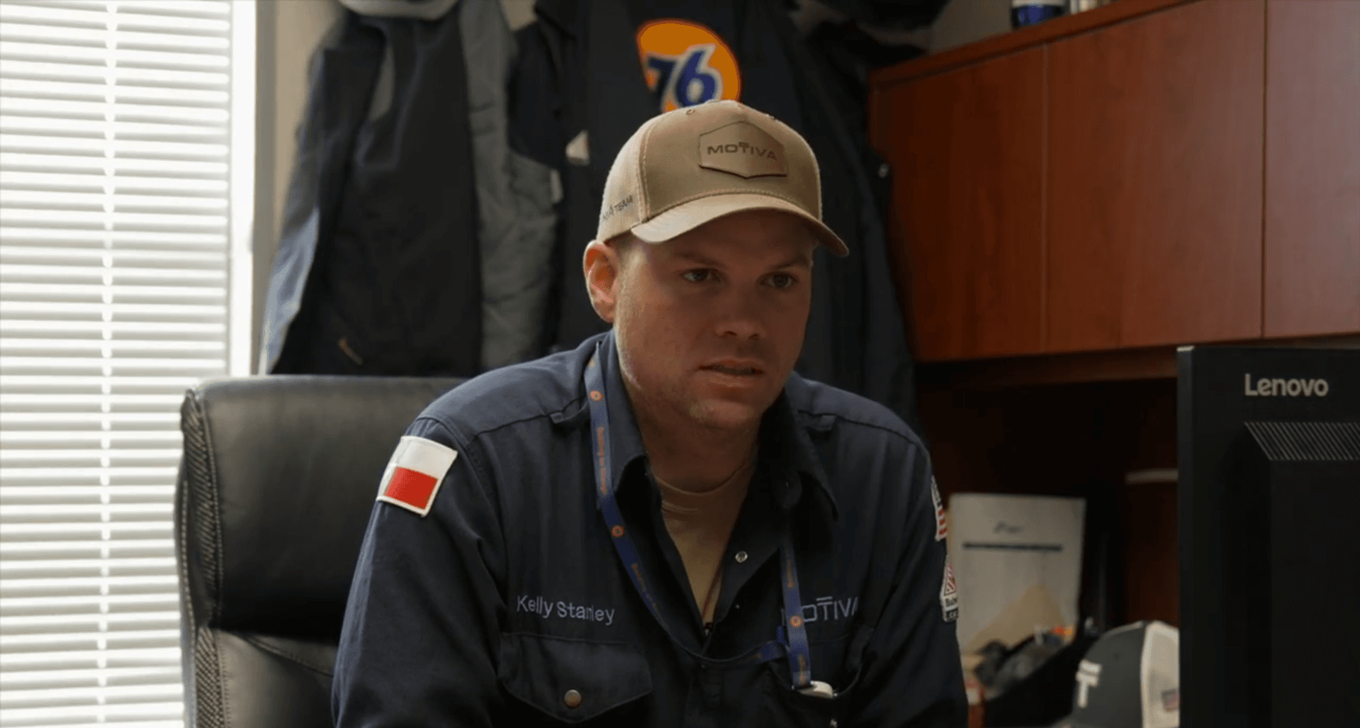 A male Motiva employee, Kelly Stanley, sits at his desk.