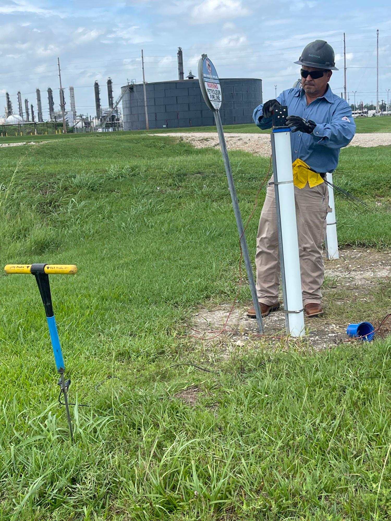 Man hammering for pipeline maintenance